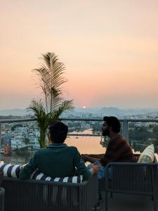 two men sitting on a balcony watching the sunset at Bunkyard in Udaipur
