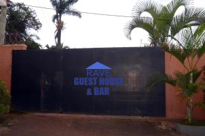 a black fence with a sign on it at Rave Guest House and Bar in Mukono