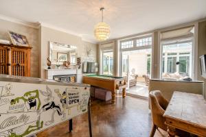 a living room with a pool table in it at Old Lakenham by Group Retreats in Boughton Monchelsea
