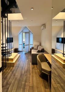 a bedroom with a bed and a living room with wooden floors at RUBEL APARTHOTEL&SPA in Yaremche