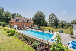 a swimming pool in the backyard of a house at Old Lakenham by Group Retreats in Boughton Monchelsea