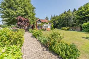 a brick path in front of a house at Old Lakenham by Group Retreats in Boughton Monchelsea