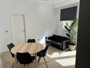 Una sala de estar con una mesa y sillas y un sofá. en The Place Tenerife, en Santa Cruz de Tenerife