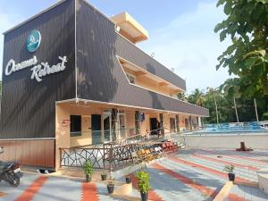 a building with a motorcycle parked in front of it at Oceanus Retreat in Kottiyam