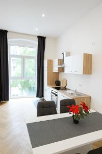 a living room with a kitchen and a table at Céleste Suites in Vienna +5 photos