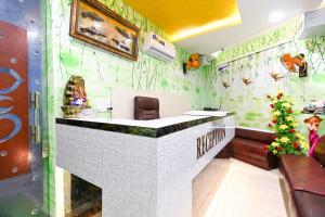 a bar in a restaurant with green wallpaper at Collection O Royal King in Rohtak