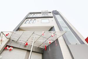 a building with red and white balloons hanging from it at Collection O Royal King in Rohtak