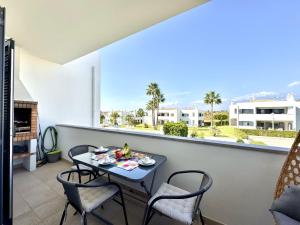 a table and chairs on a balcony with a view at Pêra Secret Garden 2 With Pool by Homing in Pêra