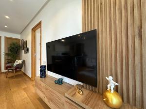 a living room with a large flat screen tv at Sea and Marina View - By AppartAli in Casablanca-Port