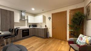 a kitchen and living room with a couch and a table at Sea and Marina View - By AppartAli in Casablanca-Port +22 photos