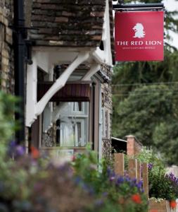 a red lion sign on the side of a house at The Red Lion Hotel in Cambridge