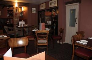 a dining room with tables and chairs in a restaurant at The Red Lion Hotel in Cambridge