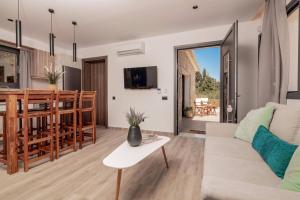 a living room with a couch and a table at Villa Halakas by Villa Plus in Katastárion