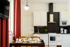 a kitchen with a table with food on it at Hotelli Ville in Tampere