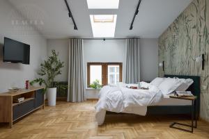 a bedroom with a bed and a television in it at Art Palace - Fragola Apartments in Kraków +12 photos
