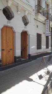 a building with wooden doors on a street at Hotel Santiago Yungay in Santiago