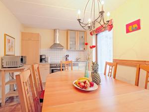 a kitchen with a wooden table with a plate of fruit on it at Fischerhaus Rechlin in Zielow