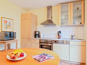 a kitchen with a table with a bowl of fruit on it at Fischerhaus Rechlin in Zielow