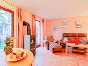 a living room with a couch and a fireplace at Fischerhaus Rechlin in Zielow