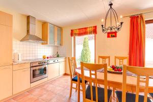 a kitchen and dining room with a table and chairs at Fischerhaus Rechlin in Zielow +30 photos