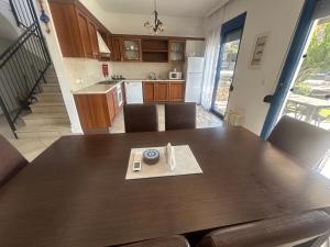 a kitchen with a wooden table and a dining room at Villa Poseidon Blue in Rhodes Town