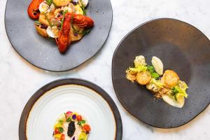 three plates with food on them on a table at Golden Tulip Hotel Central in Den Bosch +123 photos