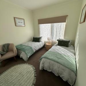 a bedroom with two beds and a window at Neeri Home in Neerim South