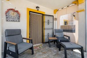 two chairs and a table on a porch at Siam's House in Villacosta