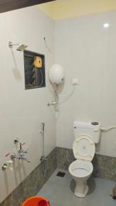 a bathroom with a toilet and a sink at Sai Homestay Tarkarli in Malvan