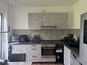 a kitchen with stainless steel cabinets and a stove at Beautiful 3-room apartment in Lohmar in Lohmar