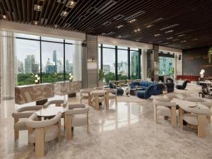 a lobby with tables and chairs in a building at SO/ Bangkok in Bangkok