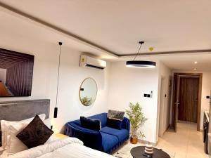a living room with a blue couch and a blue chair at Tranquil Studio in Belrose Place, Accra in Accra +5 photos