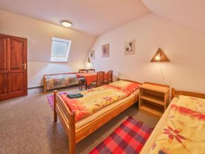a bedroom with two beds and a table at Holiday Home Lika by Interhome in Úhlejov