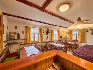 a living room with chairs and a dining room at Holiday Home Lika by Interhome in Úhlejov