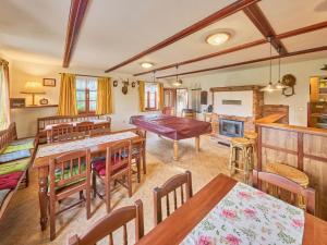 a dining room with tables and chairs and a fireplace at Holiday Home Lika by Interhome in Úhlejov