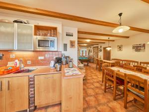 a kitchen with wooden cabinets and a dining room at Holiday Home Růžovka by Interhome in Úhlejov +68 photos