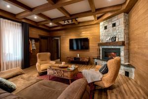 a living room with a couch and a fireplace at Shamuk Homes in Chimgan