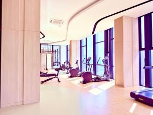 a gym with treadmills and ellipticals in a building at AXON RESIDENCE BUKIT BINTANG KLCC by FIRST CLASS in Kuala Lumpur