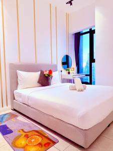 a bedroom with a large white bed in a room at AXON RESIDENCE BUKIT BINTANG KLCC by FIRST CLASS in Kuala Lumpur