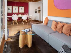 a living room with a couch and a table at Apartment Chesa Vadret 12 by Interhome in Pontresina +24 photos