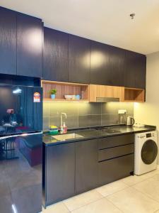 a kitchen with a sink and a washing machine at AXON RESIDENCE BUKIT BINTANG KLCC by FIRST CLASS in Kuala Lumpur +27 photos