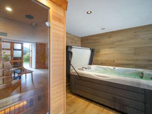 a jacuzzi tub in a room with wooden walls at Chalet Lana by Interhome in Mrzli Dol