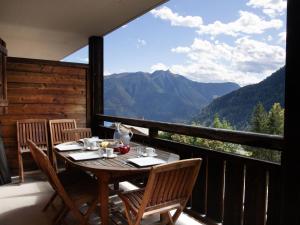 a table on a balcony with a view of mountains at Apartment Les Chalets de Marie A 22 by Interhome in Ovronnaz