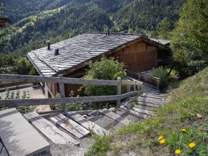 a wooden house with stairs leading up to it at Apartment Les Chalets de Marie A 22 by Interhome in Ovronnaz
