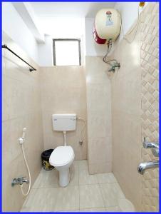 a small bathroom with a toilet and a shower at Rooftop Sea View Boutique Shivangi Hotel Near Jagannath Temple 1400m - Restaurant- Lift and Free Parking Facilities - Fully Air Conditioning Premium Rooms- Best Sea Beach Hotel In Puri in Puri