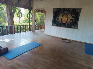 a room with two blue mats on a wooden floor at Babazia Community in Pai