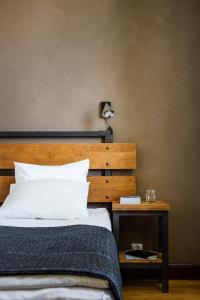 a bedroom with a bed and a side table at Hotelli Ville in Tampere