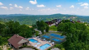 an aerial view of a resort with two tennis courts at Sleeps 24 2 Homes Hot Tub Sauna Movie Theater Firepit Pool Tennis Courts in Gatlinburg