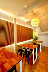a dining room with wooden tables and black chairs at Rotorua Downtown Backpackers in Rotorua
