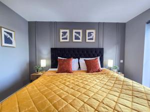 a bedroom with a large bed with red pillows at Stunning Liverpool Dockside Apt by City SuperHost in Liverpool